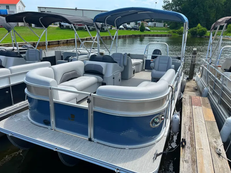 Slide: The Image of 2023 Landau Island Breeze 232 Cruise pontoon boat docked by the water. - 10