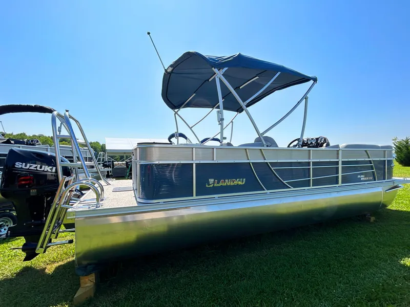 Slide: The Image of 2023 Landau Island Breeze 232 Cruise pontoon boat with canopy on grassy area. - 3