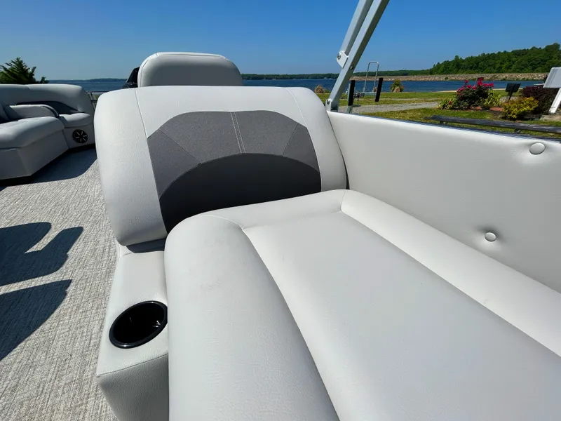 Slide: The Image of 2023 Landau Island Breeze 232 Cruise pontoon boat with comfortable seating and scenic lake view. - 5