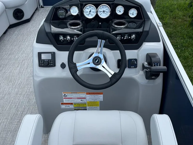 Slide: The Image of 2025 Landau Island Breeze 232 Cruise dashboard with steering wheel and gauges. - 4