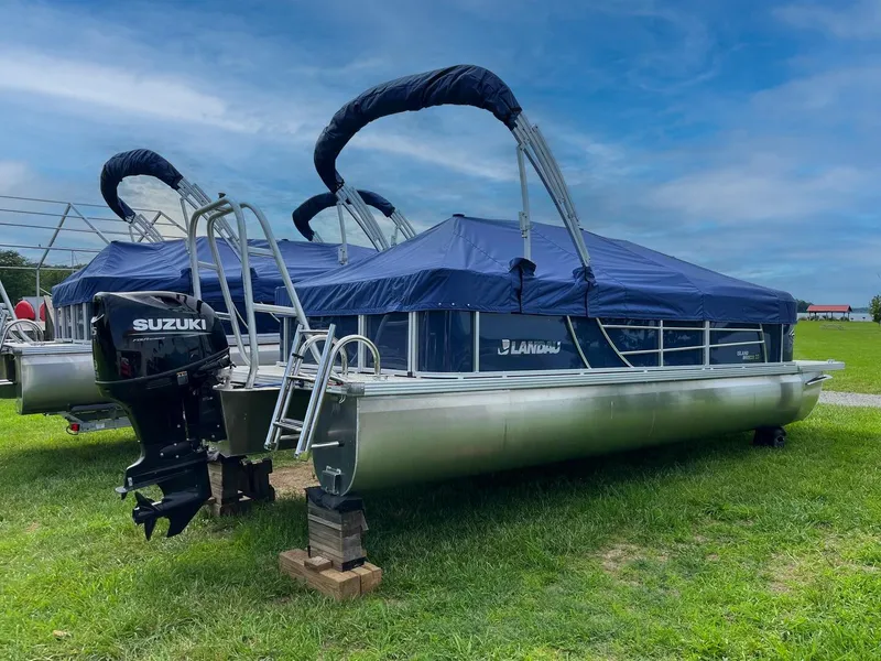 Slide: The Image of 2025 Landau Island Breeze 232 Cruise pontoon boat with Suzuki motor on grassy field. - 5
