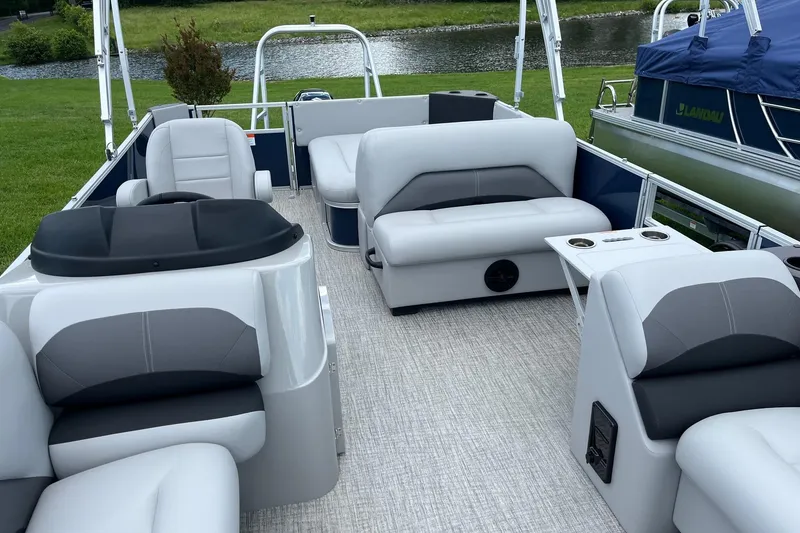Slide: The Image of 2025 Landau Island Breeze 232 Cruise pontoon boat interior with plush seating and cup holders. - 8