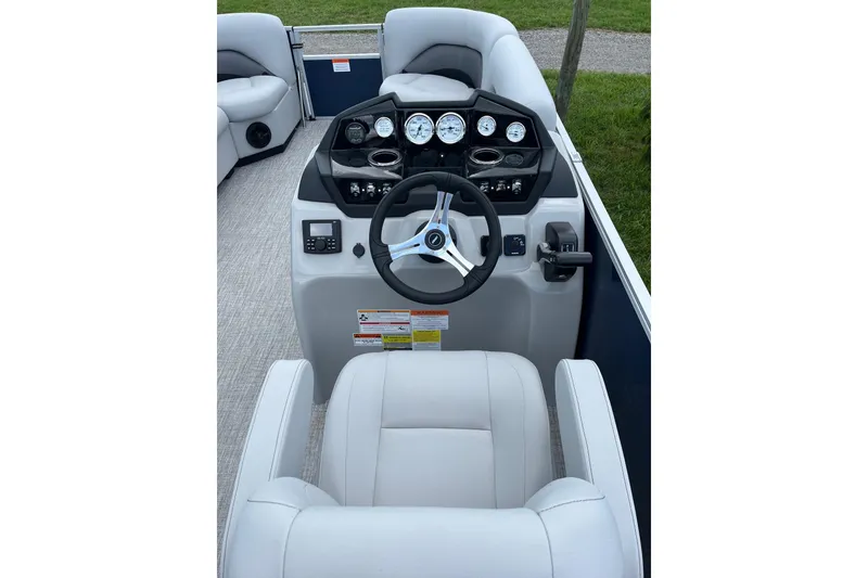 Slide: The Image of 2025 Landau Island Breeze 232 Cruise boat dashboard with steering wheel and gauges. - 9