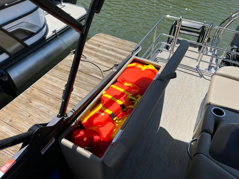 Slide: The Image of Storage compartment on 2025 Starcraft EXS 3 Q DH boat with life jackets. - 11