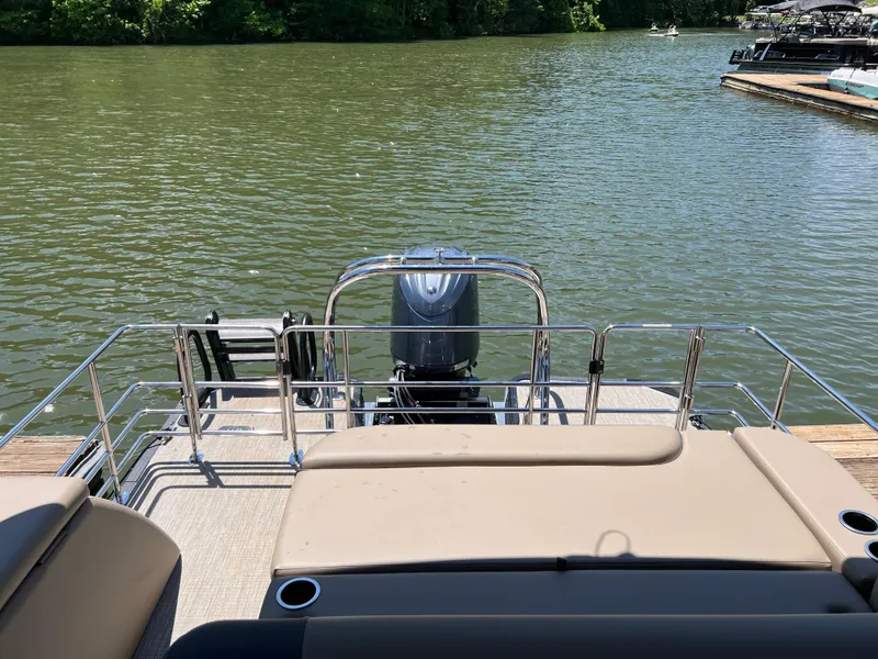 Slide: The Image of 2025 Starcraft EXS 3 Q DH pontoon boat on a serene lake. - 14