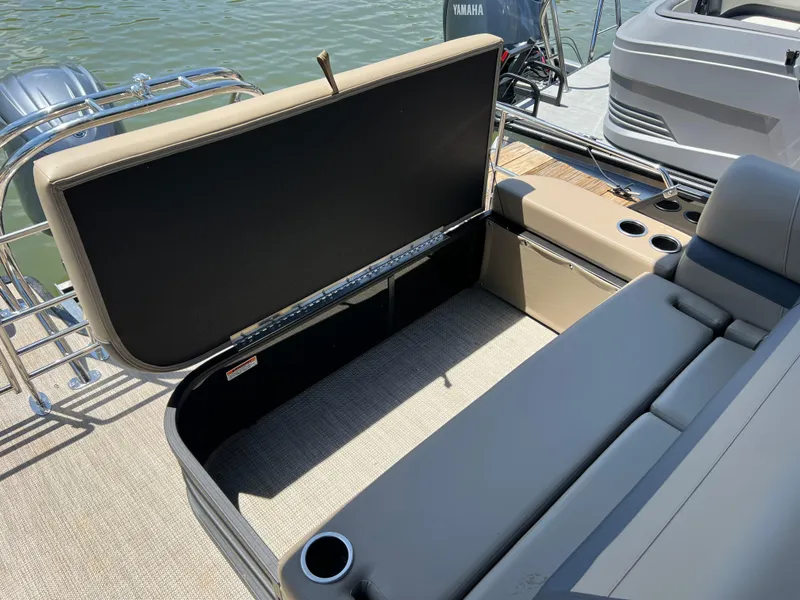 Slide: The Image of 2025 Starcraft EXS 3 Q DH boat with open storage compartment and seating. - 16