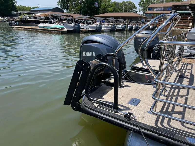 Slide: The Image of Starcraft EXS 3 Q DH 2025 pontoon boat with Yamaha engines docked at marina. - 17