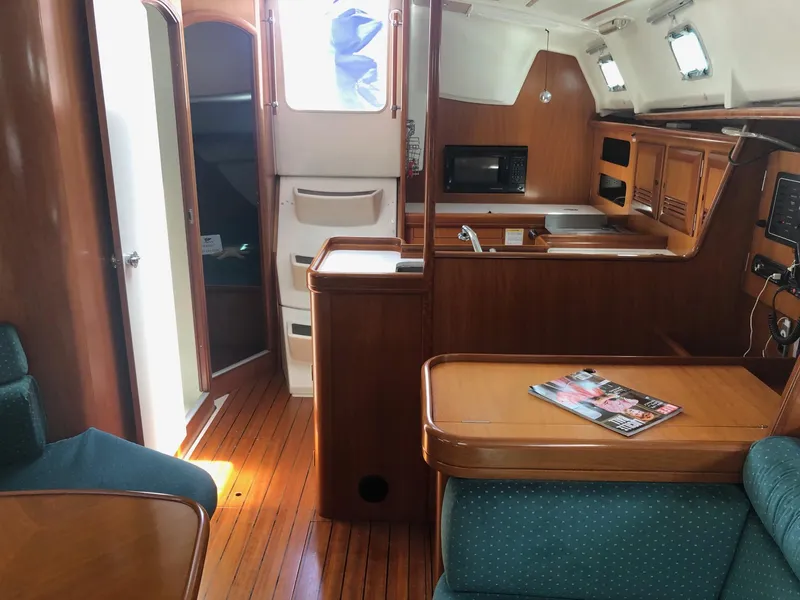 Slide: The Image of Interior of 2001 Beneteau 361 sailboat with wood finish and modern amenities. - 14