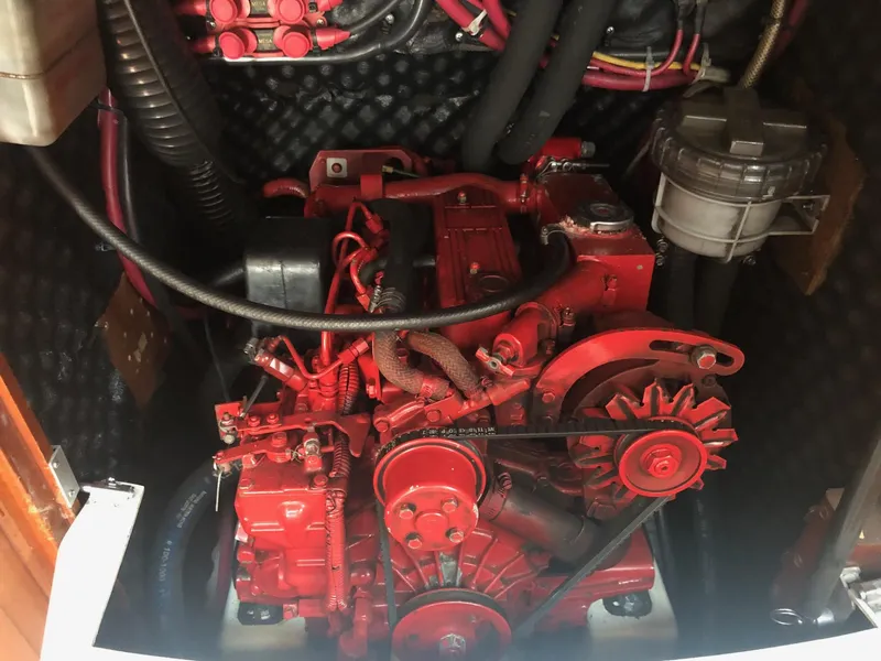 Slide: The Image of Engine compartment of a 2001 Beneteau 361 sailboat, featuring a red marine engine. - 15