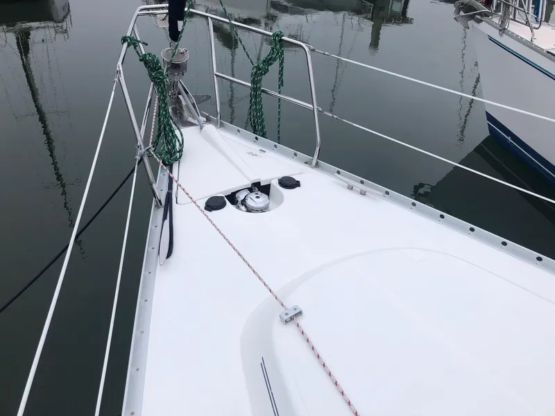 Slide: The Image of Bow of a 2001 Beneteau 361 sailboat docked in calm waters. - 18