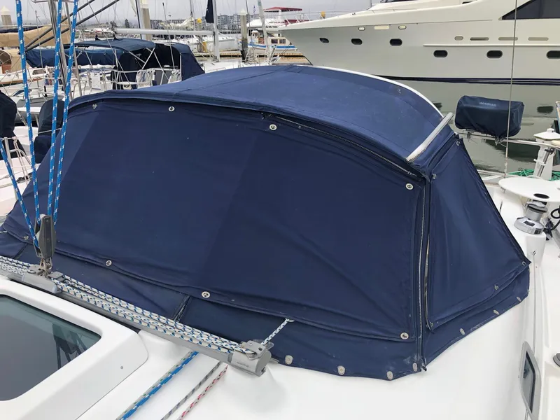 Slide: The Image of Blue canvas cover on a 2001 Beneteau 361 sailboat, docked at a marina. - 23