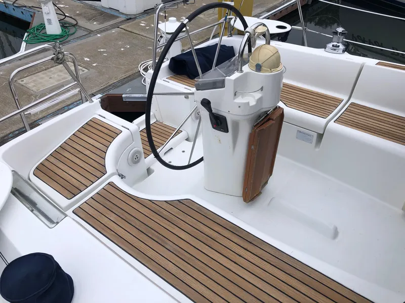 Slide: The Image of Cockpit of 2001 Beneteau 361 sailboat with wooden deck and steering wheel. - 24