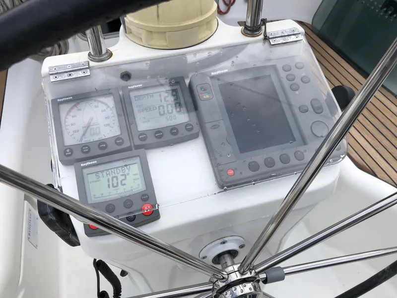 Slide: The Image of Steering console of a 2001 Beneteau 361 sailboat with navigation instruments. - 25