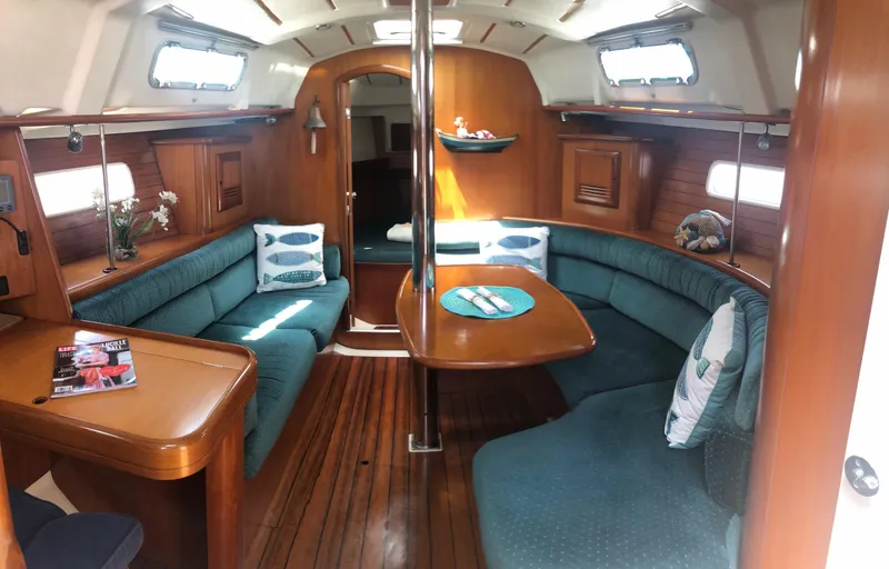 Slide: The Image of Interior of 2001 Beneteau 361 sailboat with cozy seating and wooden finishes. - 3