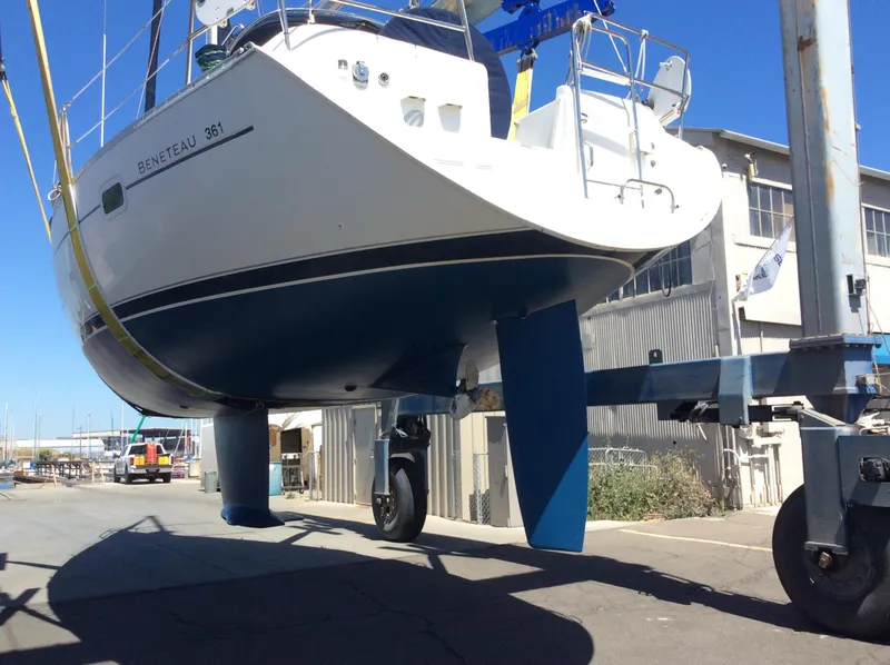 Slide: The Image of 2001 Beneteau 361 sailboat on a lift, showcasing hull and keel design. - 31