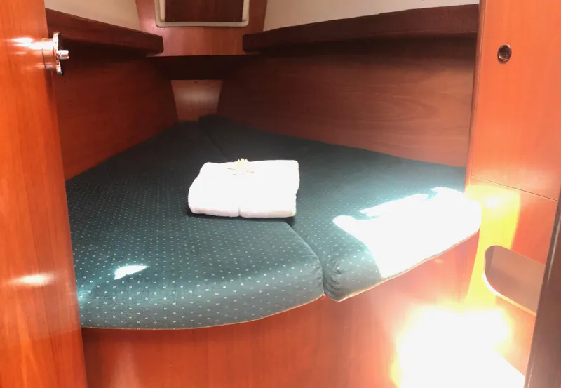 Slide: The Image of Cozy cabin interior of 2001 Beneteau 361 sailboat with neatly folded towel. - 7