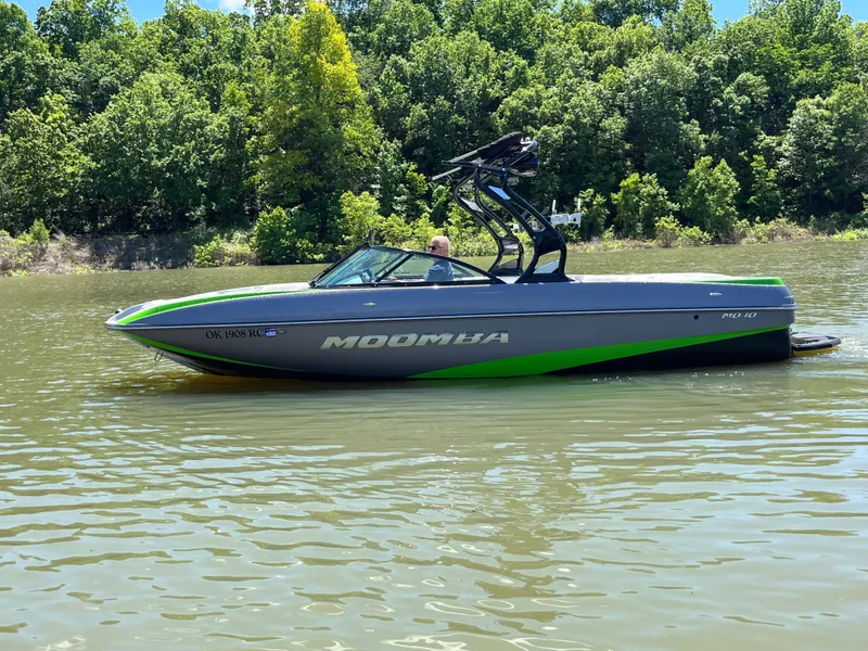 Slide: The Image of 2016 Moomba Mojo boat on a lake, surrounded by lush green trees. - 10
