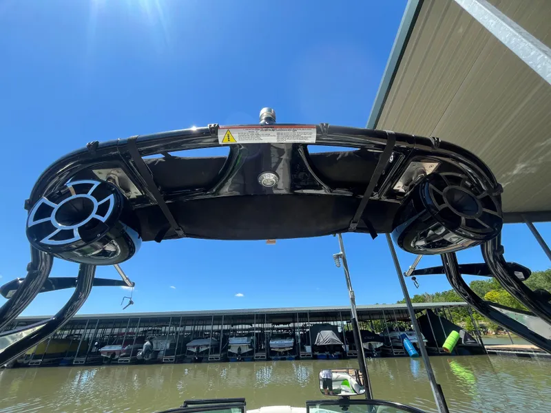 Slide: The Image of 2016 Moomba Mojo boat tower with speakers, docked under clear blue sky. - 14
