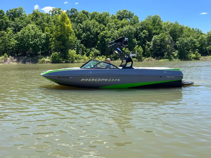 Slide: The Image of 2016 Moomba Mojo boat on a lake with lush green trees in the background. - 15