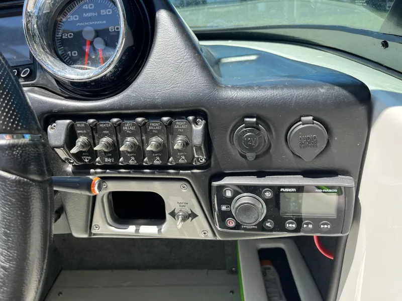 Slide: The Image of Dashboard of a 2016 Moomba Mojo boat with controls and a Fusion stereo system. - 16
