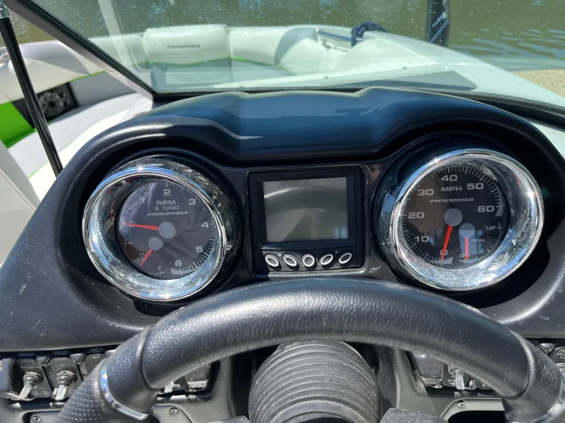 Slide: The Image of Dashboard of a 2016 Moomba Mojo boat with speedometer and tachometer. - 17