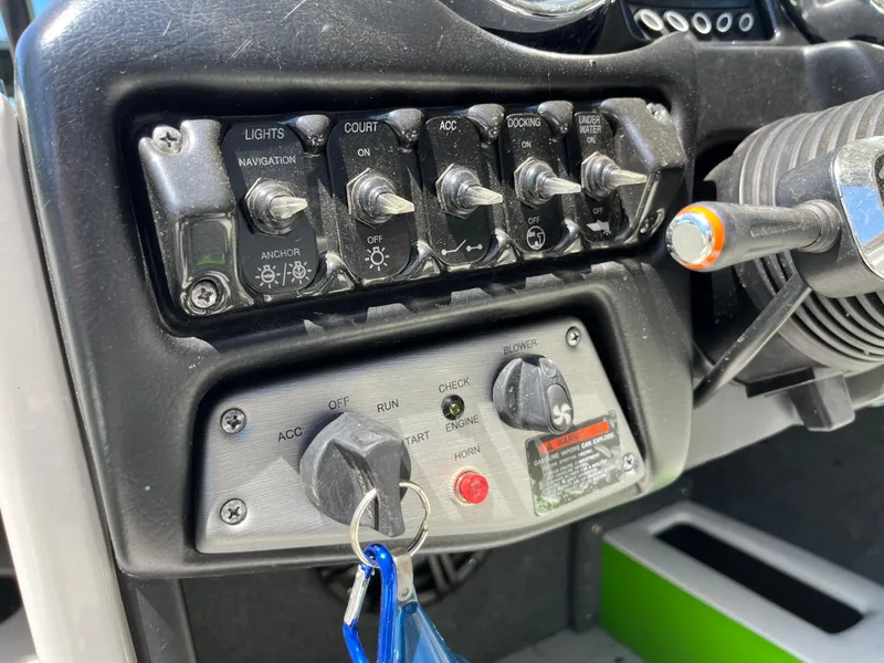 Slide: The Image of Control panel of a 2016 Moomba Mojo boat with switches and ignition. - 18