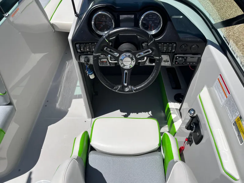 Slide: The Image of 2016 Moomba Mojo boat cockpit with steering wheel and dashboard controls. - 19