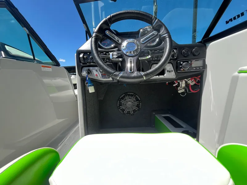 Slide: The Image of 2016 Moomba Mojo boat cockpit with steering wheel and dashboard controls. - 21