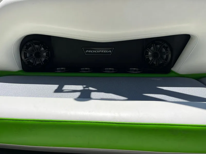Slide: The Image of 2016 Moomba Mojo boat interior with speakers and green-accented seating. - 23