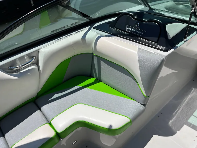 Slide: The Image of 2016 Moomba Mojo boat interior with gray and green seating. - 24