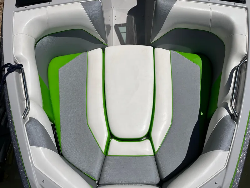 Slide: The Image of 2016 Moomba Mojo boat interior with green and gray seating. - 31