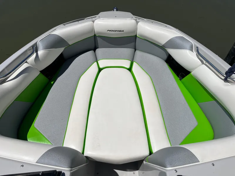 Slide: The Image of 2016 Moomba Mojo boat interior with gray and green seating. - 32