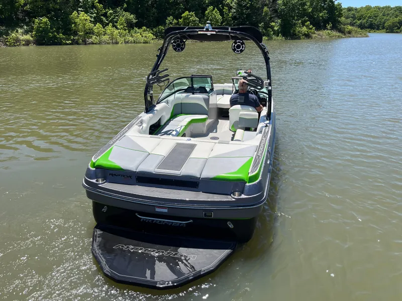 Slide: The Image of 2016 Moomba Mojo boat on a lake, featuring green accents and a wakeboard tower. - 4