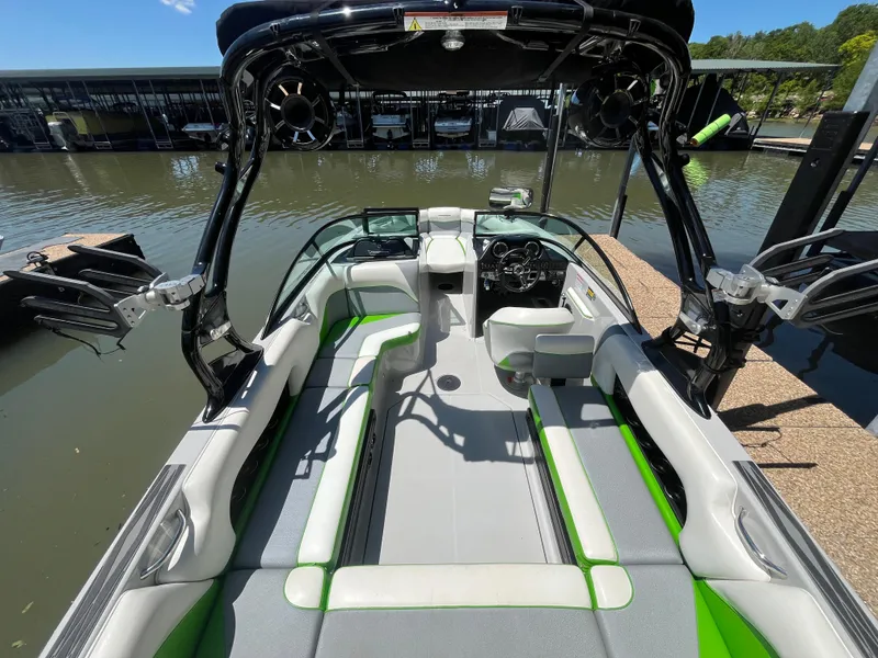 Slide: The Image of 2016 Moomba Mojo boat interior with green accents docked at a marina. - 42