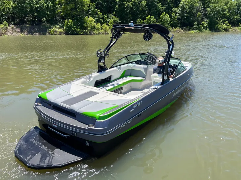 Slide: The Image of 2016 Moomba Mojo boat on a lake, featuring sleek design and vibrant green accents. - 5