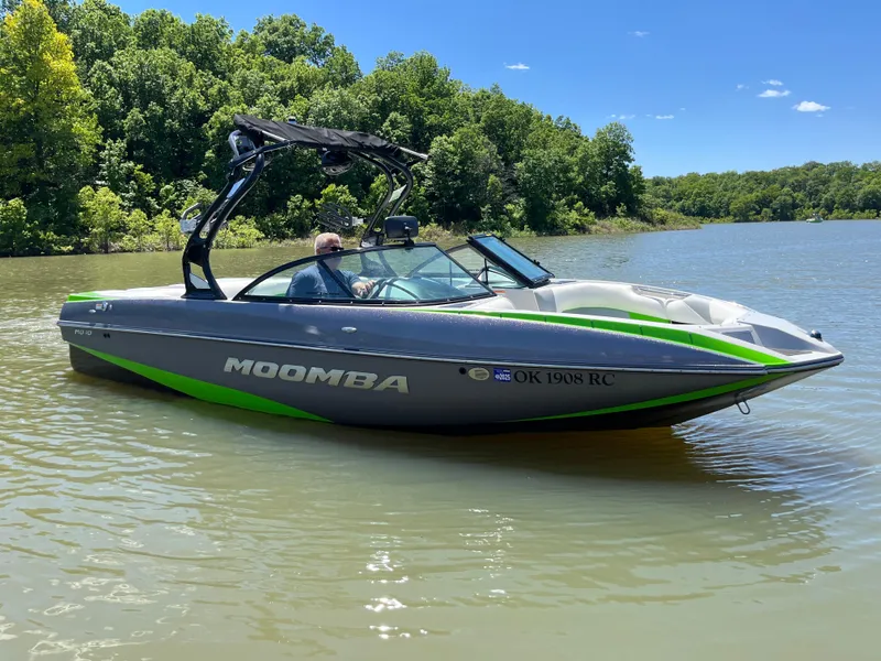 Slide: The Image of 2016 Moomba Mojo boat on a lake with lush green trees in the background. - 8