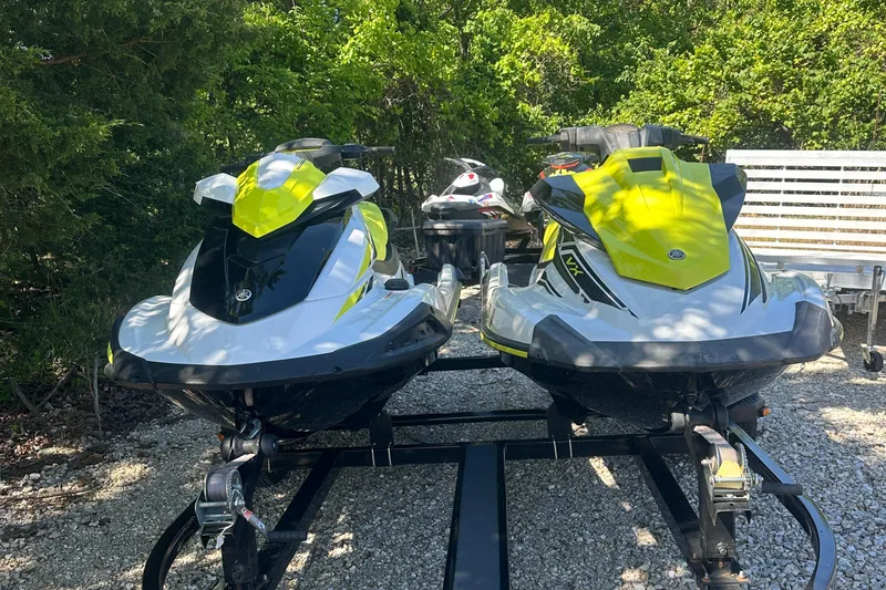 Slide: The Image of Two 2021 Yamaha WaveRunner VX jet skis on a trailer, parked outdoors. - 0