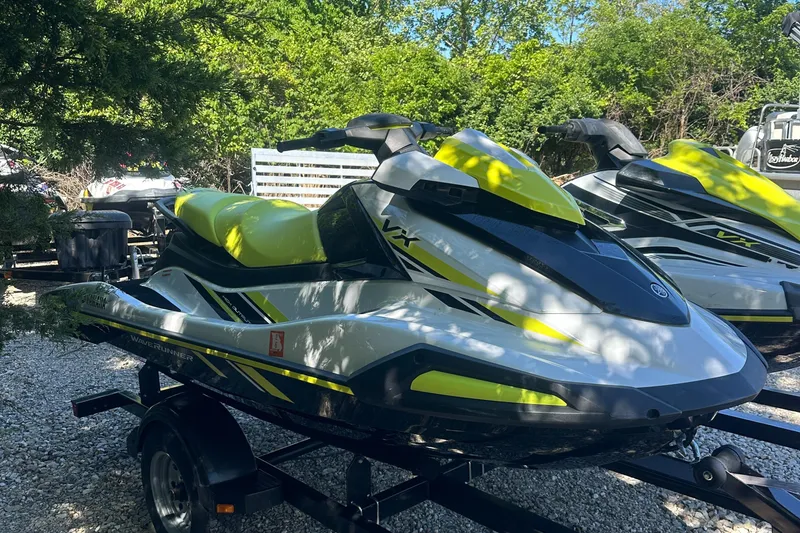 Slide: The Image of 2021 Yamaha WaveRunner VX jet ski on a trailer, surrounded by greenery. - 1