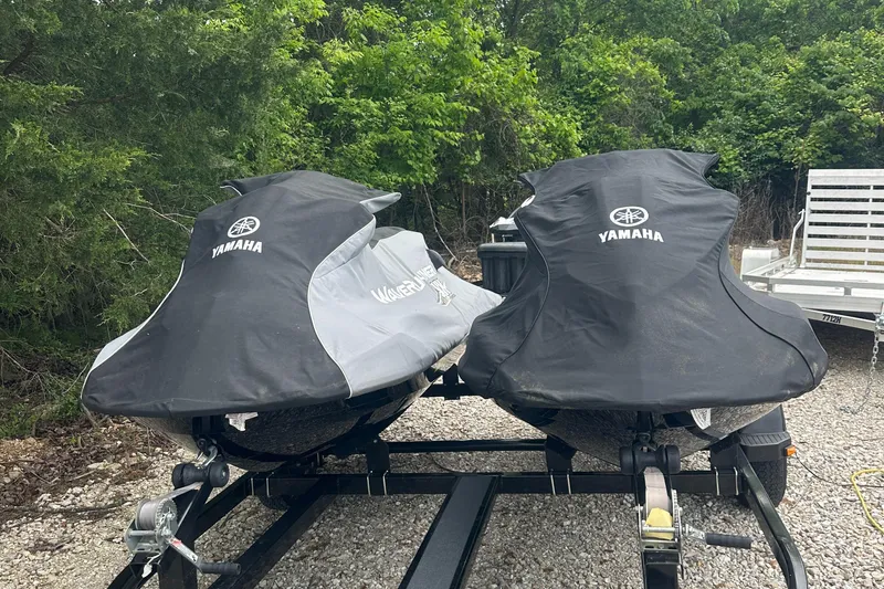 Slide: The Image of Two covered 2021 Yamaha WaveRunner VX jet skis on a trailer, surrounded by greenery. - 15