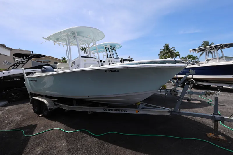 Slide: The Image of 2020 Sportsman Heritage 211 Center Console boat on trailer, parked outdoors. - 18