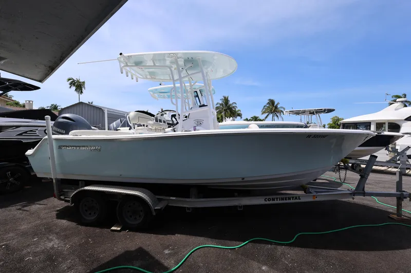 Slide: The Image of 2020 Sportsman Heritage 211 Center Console boat on trailer, parked outdoors. - 19