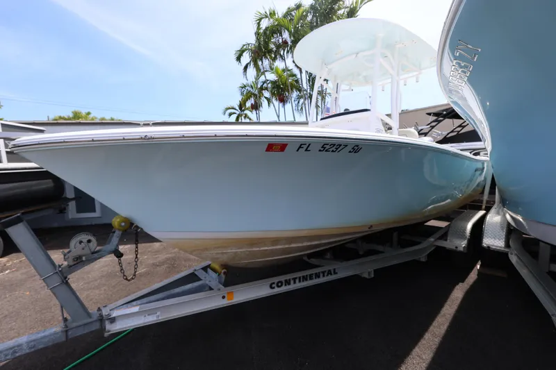 Slide: The Image of 2020 Sportsman Heritage 211 Center Console boat on trailer, parked outdoors. - 21