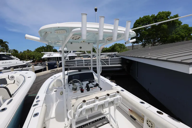 Slide: The Image of 2020 Sportsman Heritage 211 Center Console boat with T-top and rod holders. - 24