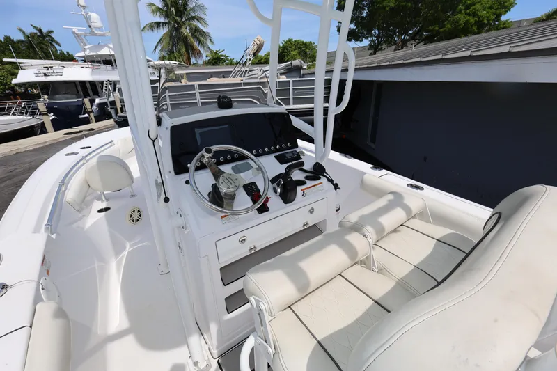 Slide: The Image of 2020 Sportsman Heritage 211 Center Console boat interior with steering wheel and seating. - 26