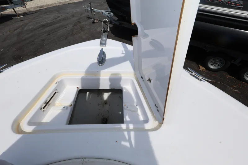 Slide: The Image of 2020 Sportsman Heritage 211 Center Console boat with open storage compartment. - 31