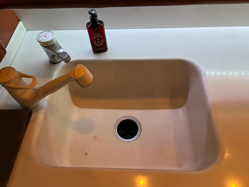 Slide: The Image of White sink with faucet and soap bottle on a Viking 58 Enclosed Bridge yacht, 2000 model. - 16