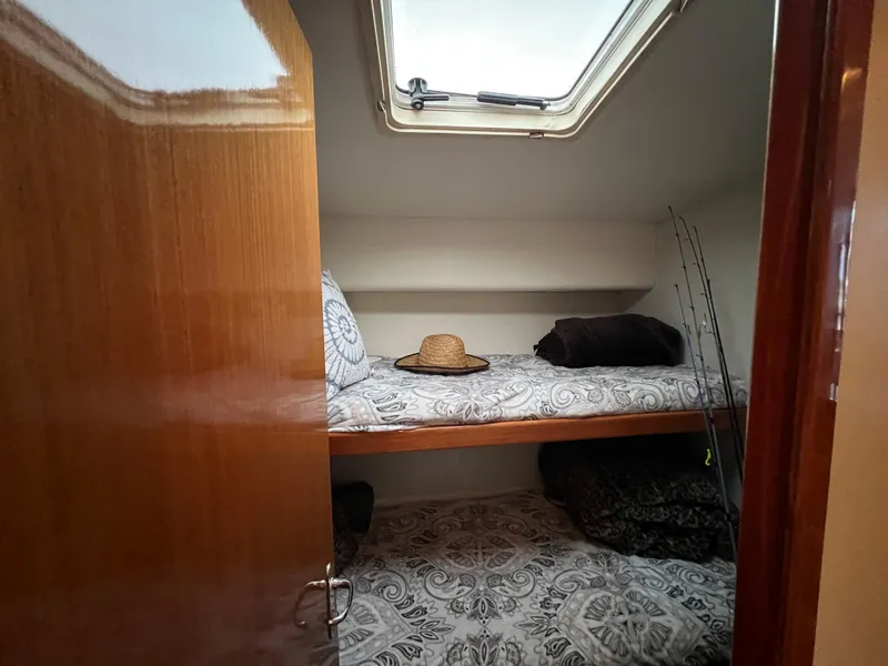 Slide: The Image of Cozy cabin interior of 2000 Viking 58 Enclosed Bridge with patterned bedding and skylight. - 21