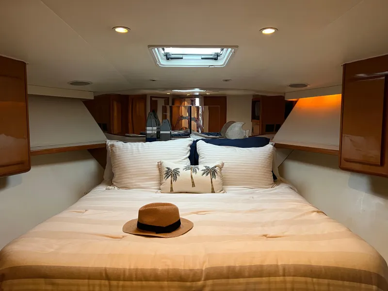 Slide: The Image of Luxurious bedroom interior of 2000 Viking 58 Enclosed Bridge yacht with cozy bedding. - 22