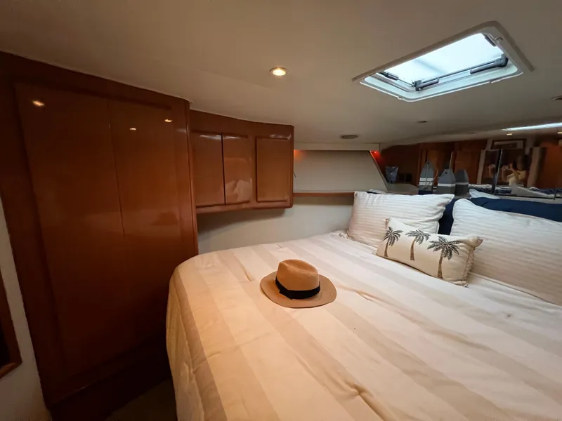 Slide: The Image of Luxurious bedroom interior of 2000 Viking 58 Enclosed Bridge yacht with cozy bedding. - 25