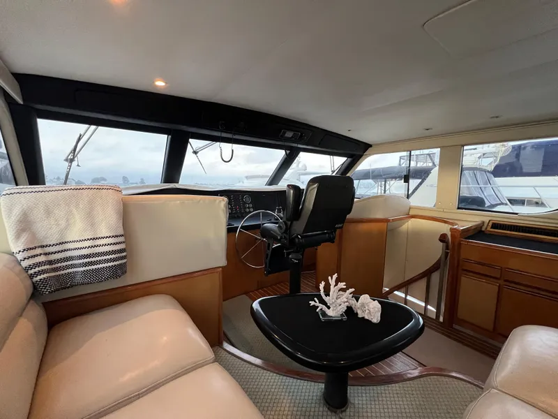 Slide: The Image of Interior of 2000 Viking 58 Enclosed Bridge yacht with helm and seating area. - 28